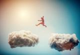 Man jumping from one cloud to another