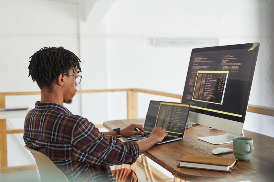young-man-remote-working-from-home-coding-programming-language.jpg