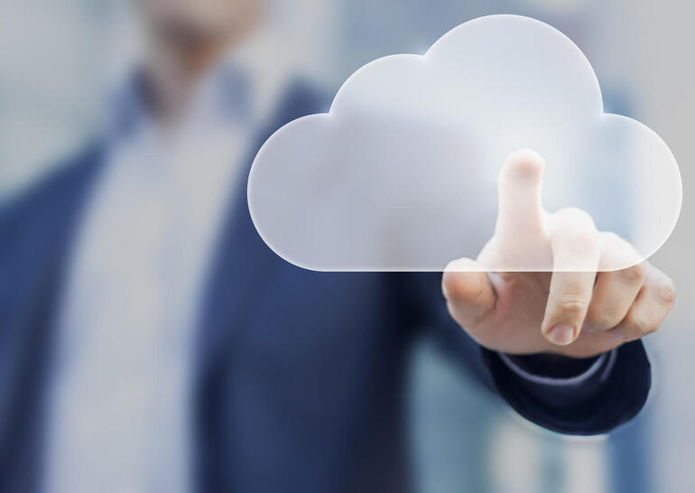 Cloud computing concept with a person touching a virtual digital icon