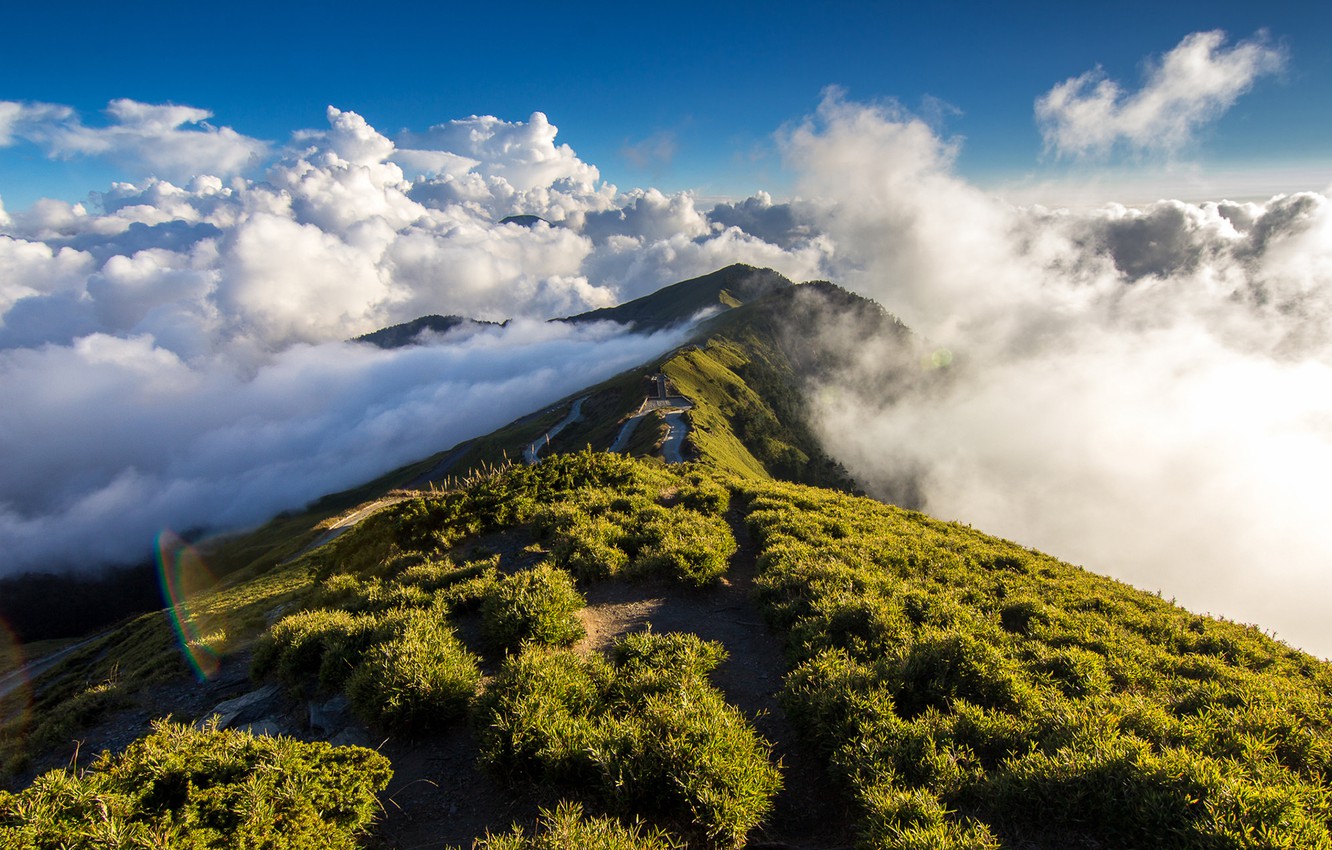 A mountain pathway through clouds.